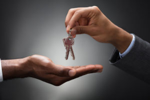 keys being passed from one hand to another