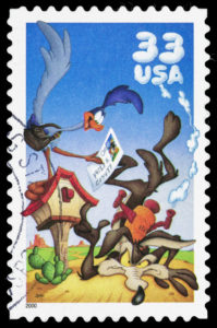 USA postage stamp with an illustration of the Looney Tunes cartoon character The Road Runner and Wile E. Coyote.