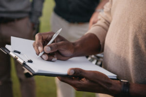 Man Checking Off a List of Inspection Items