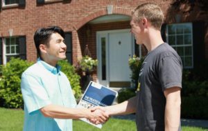 A potential resident shaking the hand of his landlord