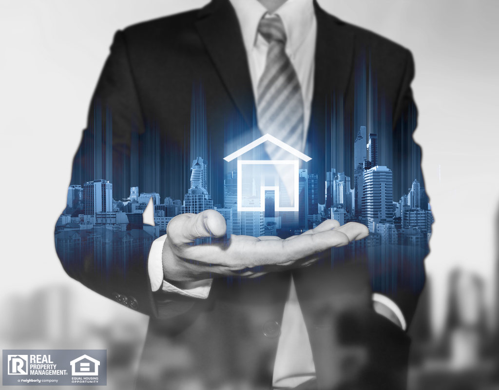 Businessman holding modern buildings hologram