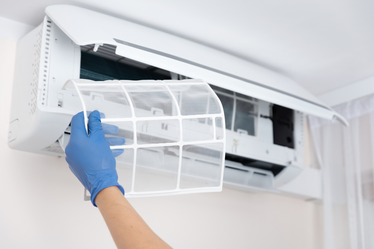 Property manager cleaning air conditioner filter