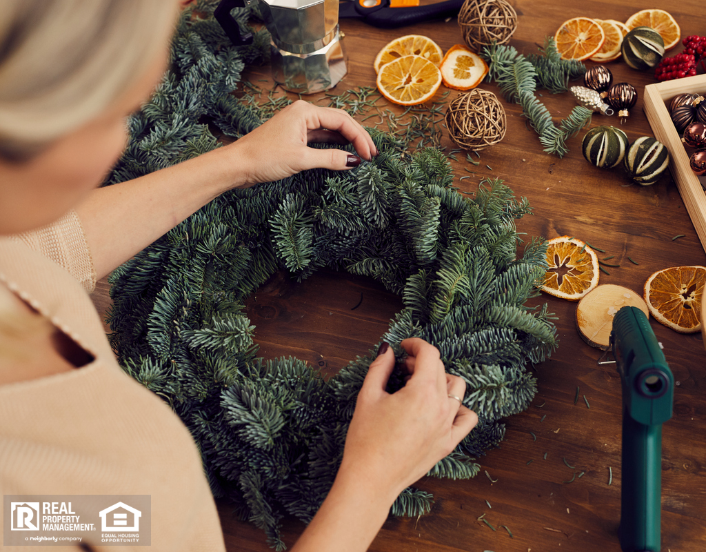Woman Crafting a Winter Wreath with Hot Glue Gun