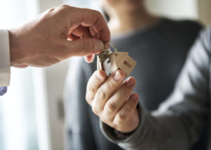 A Temecula property manager hands over keys to new tenants
