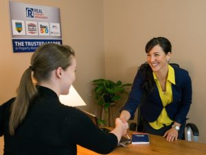 A Potential Resident Sitting at the Desk with Realevate Specialists