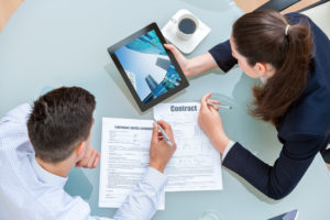 Man and woman working on rental agreement. 5 Questions NOT to ask a Potential Rentor