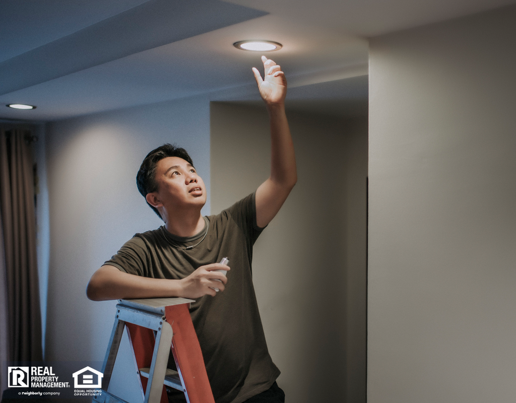 Polk County Tenant Changing a Lightbulb