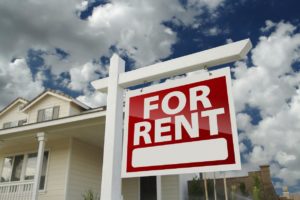 For Rent Property Management Sign in Front of House