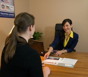A Potential Resident Sitting at the Desk with Real Property Management Sunshine Manager