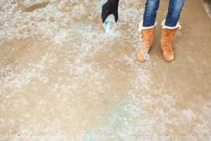 South Orlando Resident Spreading Salt on an Icy Winter Driveway