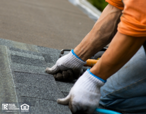 Roofer working with roofing tiles with gloves