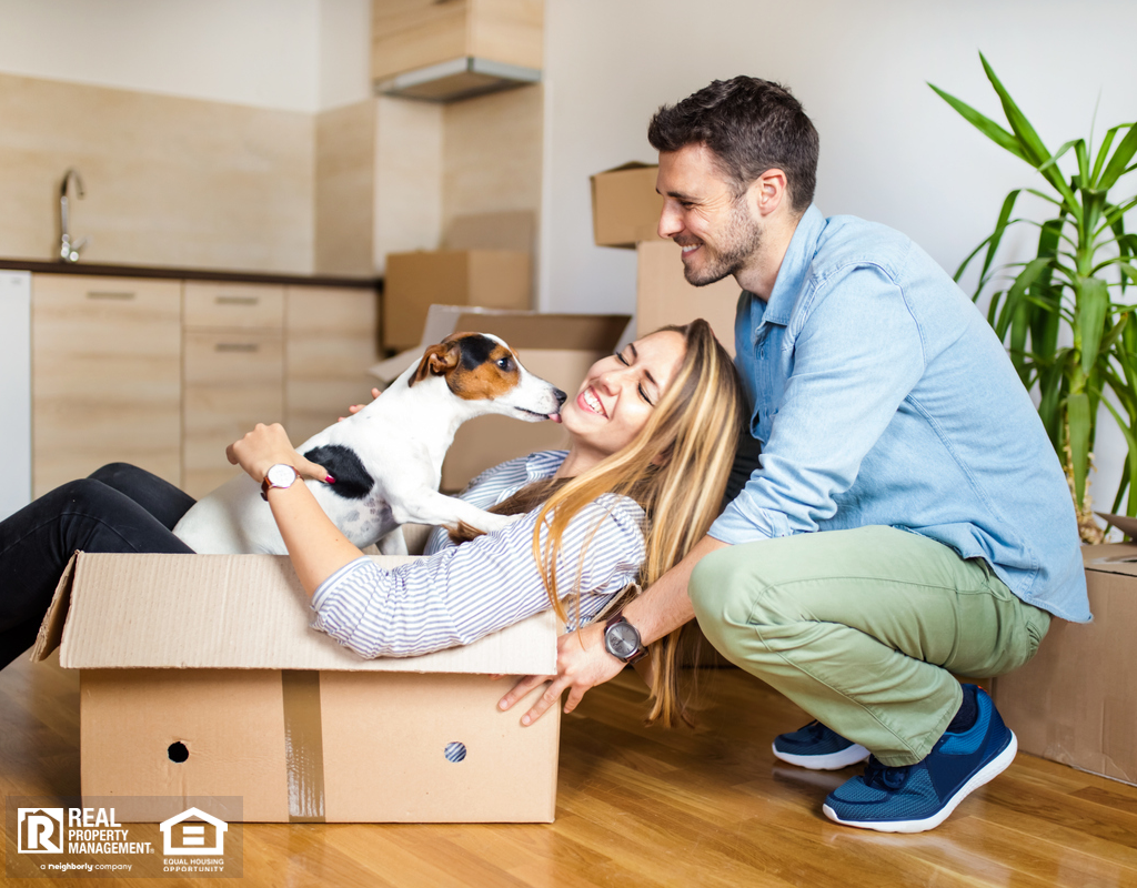 Saint Charles Couple Packing Moving Boxes with their Jack Russel Terrier