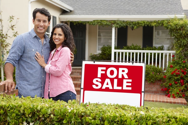 Buy and hold investing, couple outside new house