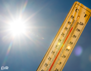 Summer heat shown on mercury thermometer against the blue sky.