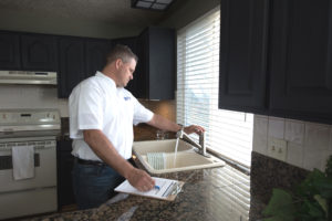 Real Property Management Gold staff inspecting the sink