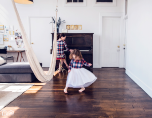 A Mother Playing the Piano While Her Daughter Dances on Hardwood Floors