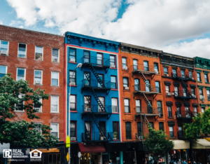 Beautiful cityscape of vintage colourful building with fire escape from residential flats and commercial real estate on ground floor