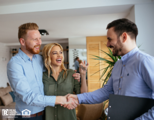 Happy Couple Closing A Great Deal on A House with Real Estate Agent