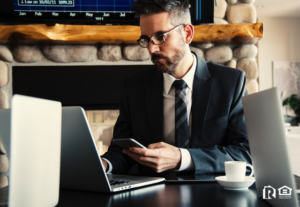 CEO Conducting Business on His Phone and Laptop