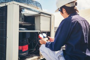 Technician Checking Air Conditioner at a Rental Home in Denton