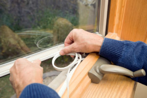 Weather Stripping Being Added to Windows as Part of the Winterizing Process in Your Brookline Rental Property
