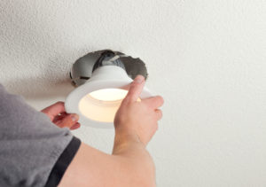 Cambridge Property Manager Installing an Energy Efficient Light Fixture