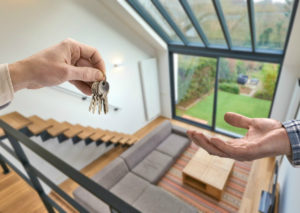 Resident Handing Keys to a Guest After Subletting Your Jamaica Plain Rental Property as an Airbnb