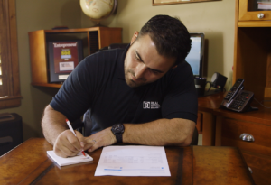 Roslindale Property Manager Making Notes About Security Deposits for Former Tenants