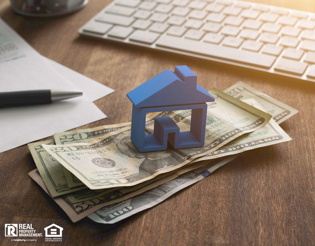 Blue Model House Stacked on Pile of Money
