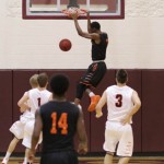 Waynesville's Kellieon Williams dunks on a fast break during the 1st half.