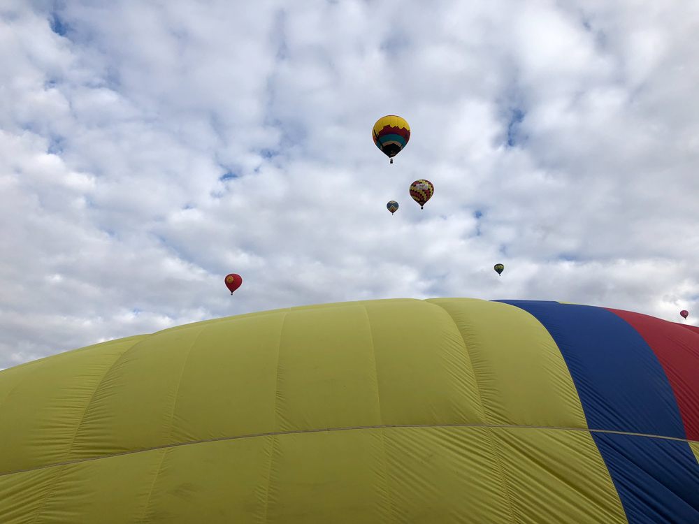 A landed balloon with some flying over