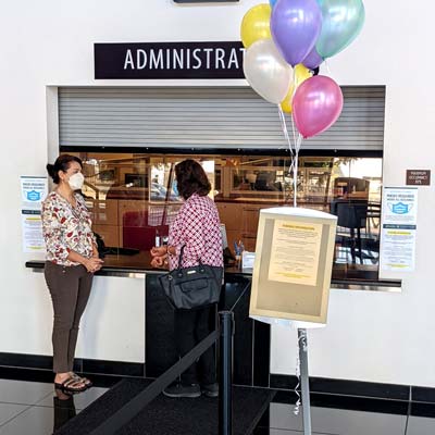 Two people talking in the Cesar Chavez Campus lobby