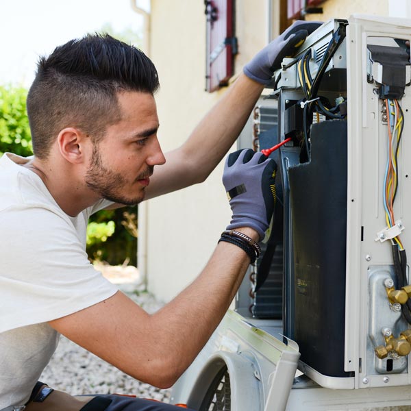 HVAC student fixing AC unit