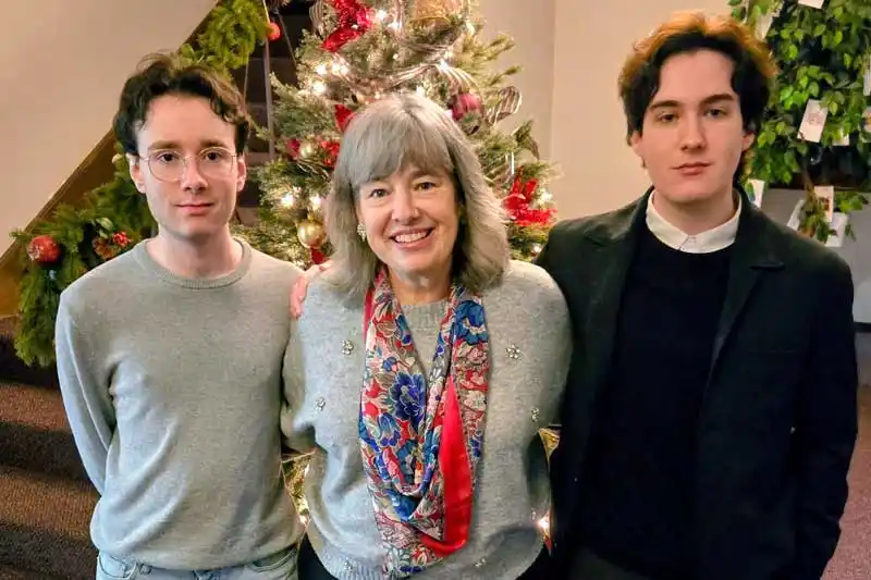 3 people in front of a Christmas tree