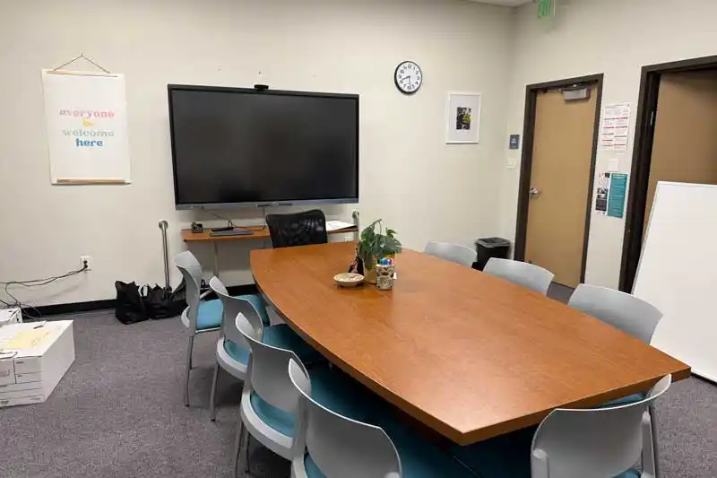 a large screen tv and conference table