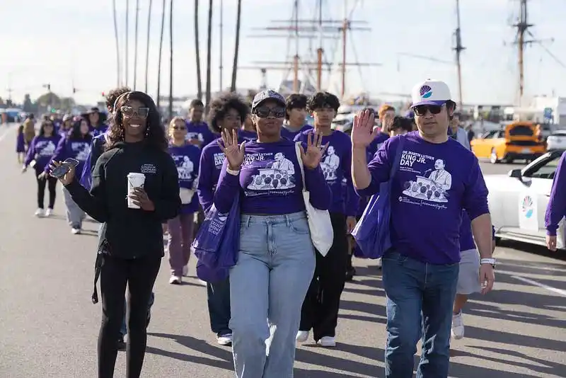 parade participants walking and waving