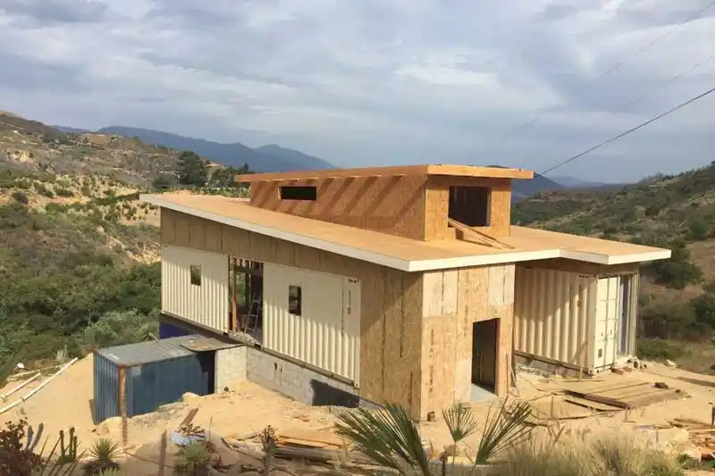 a house partially constructed from a cargo container