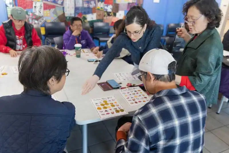 a group of people at a table playing a game