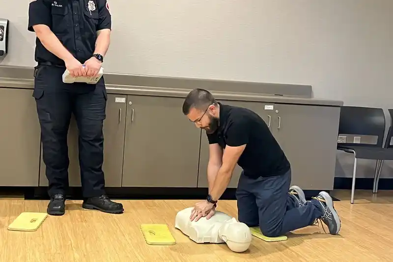 a man performing CPR on a dummy