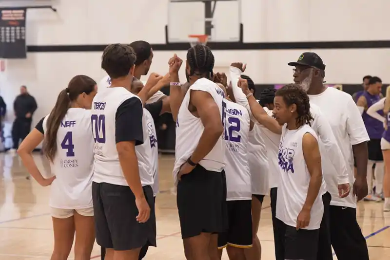 a group of people playing basketball