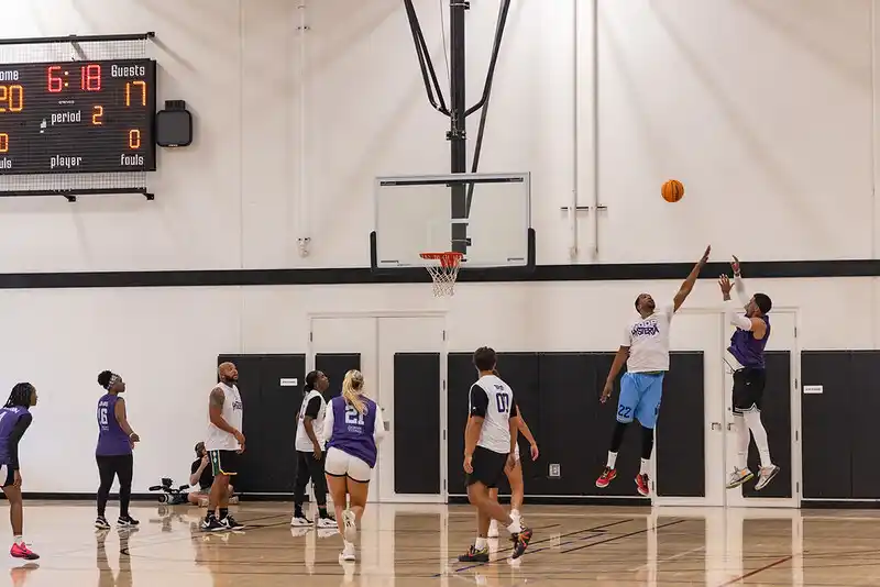 a group of people playing basketball