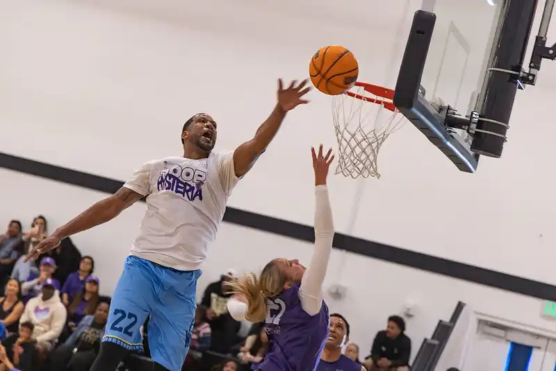 a group of people playing basketball