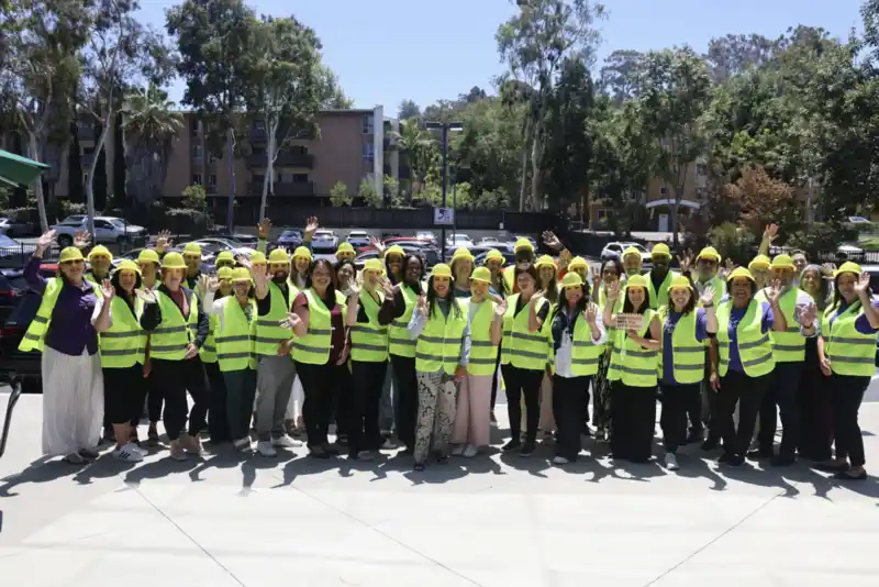 a group of people wearing construction helmets and vests