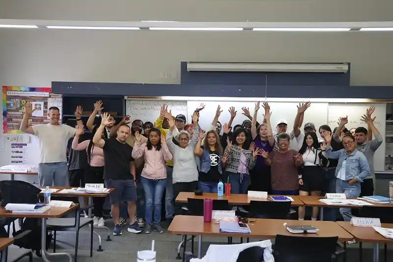 group of happy students in classroom