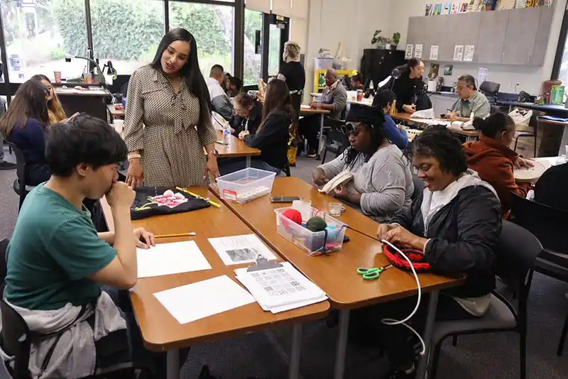 Tina King looking at student artwork