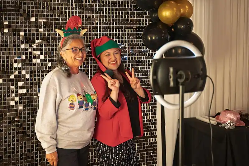 two people posing for a holiday picture