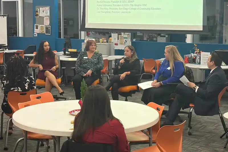 Tina King in panel discussion in cafeteria