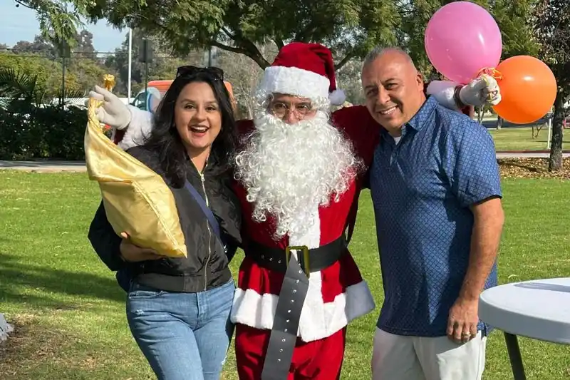 3 people. 1 person in a santa costume