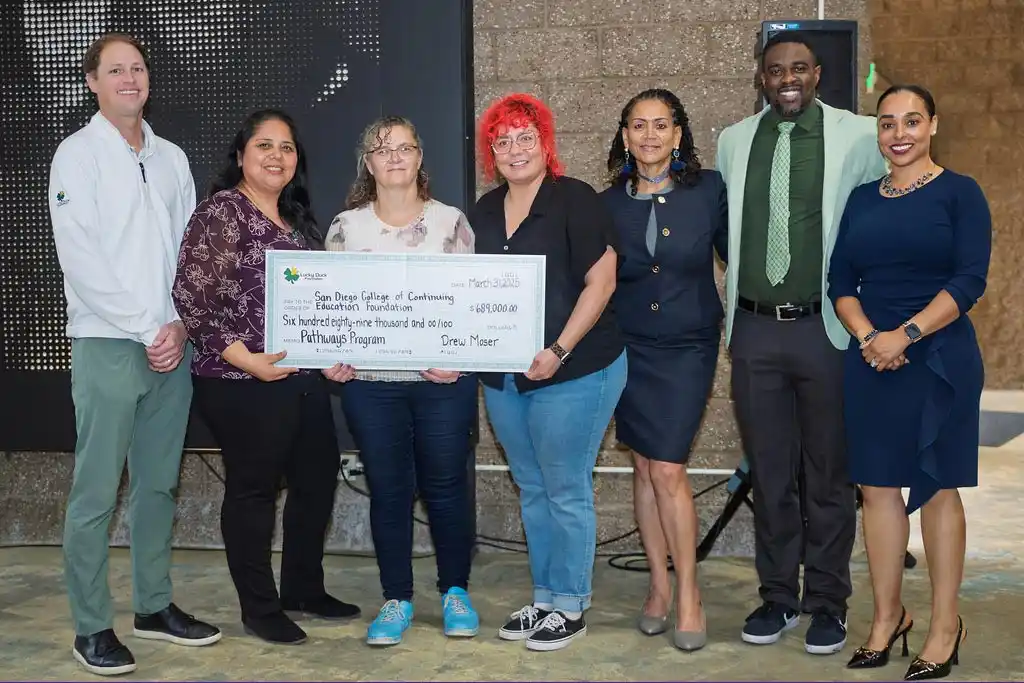 group of people with a giant check