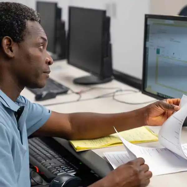 Man a computer with notes